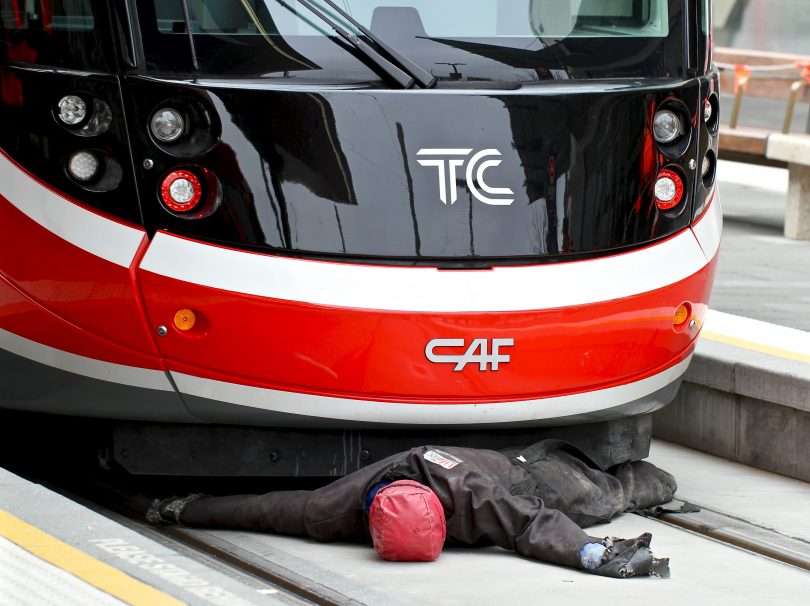 A mannequin trapped under light-rail vehicle