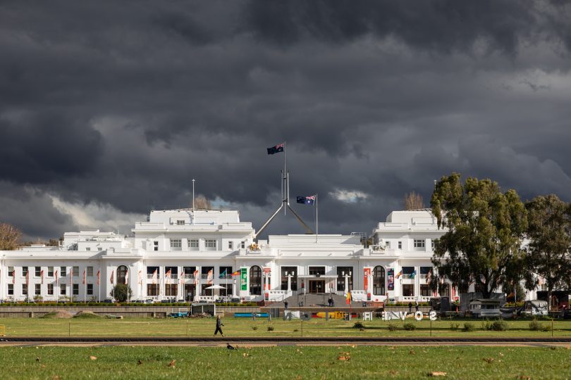 Wind and dark storm clouds approaching Parliament House & Old Parliament House. Photo: Michelle Kroll