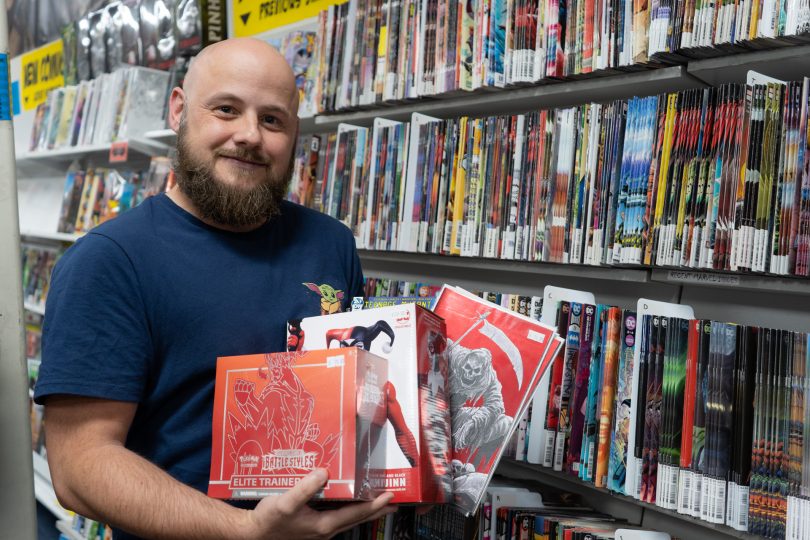 Daniel Rathbone holding comics and collectables