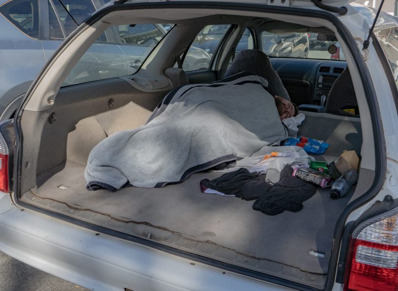 Man sleeping in the back of his car