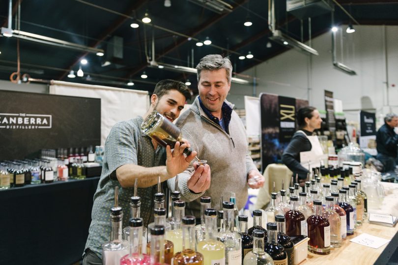 Two men from The Canberra Distillery pouring spirits