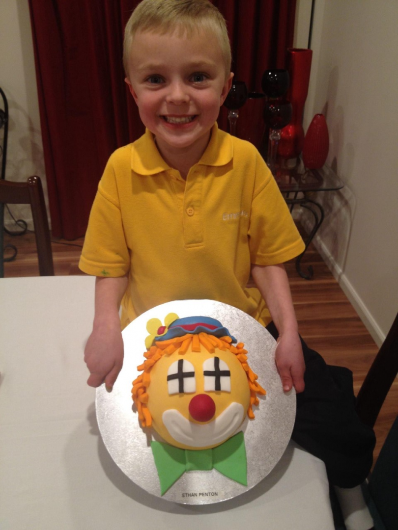 Boy with clown cake