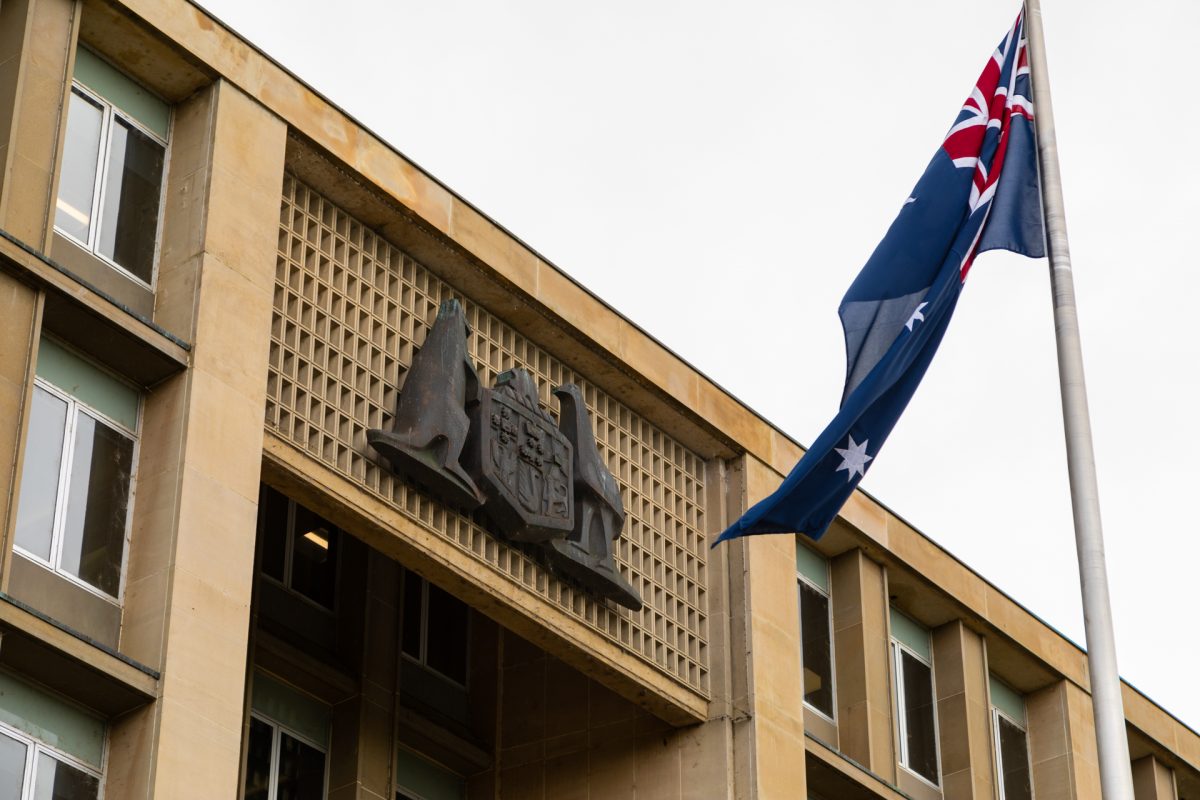 Government building with Coat of Arms and Australian flag.