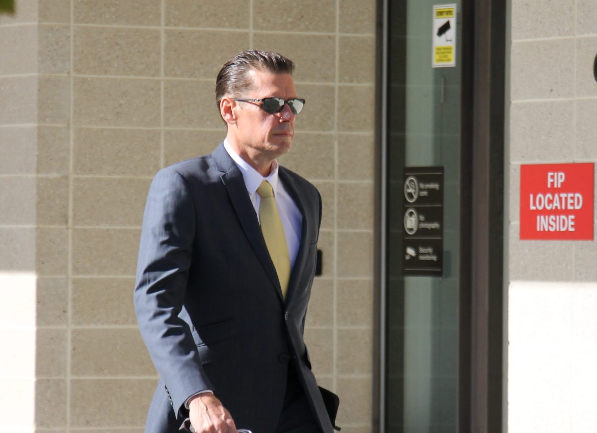 man in suit and sunglasses approaching court