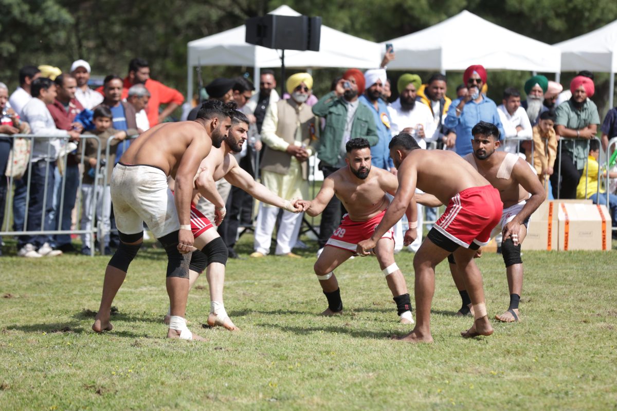 Men playing Kabbadi, a sport similar to wrestling, at Khed Mela