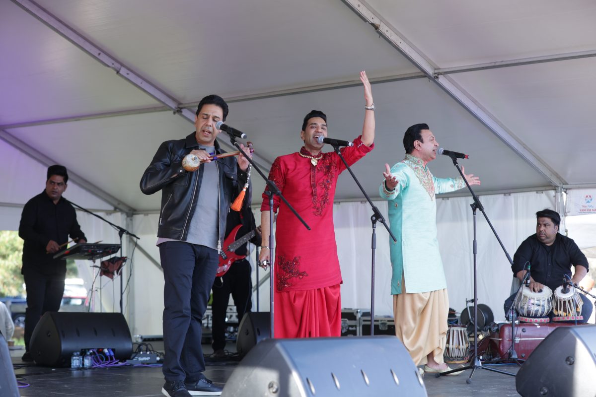 Men singing and playing instruments at Khed Mela concert