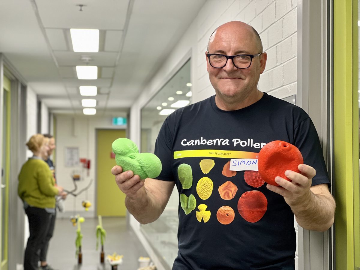 Dr Simon Haberle holding pollen replicas