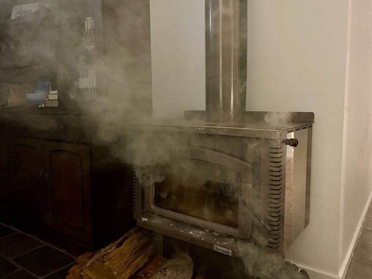 Wood heater emitting smoke