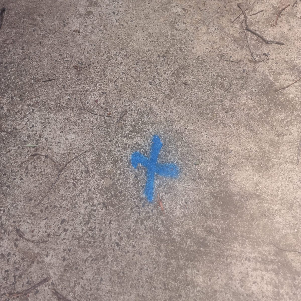 Spraypainted X mark on concrete