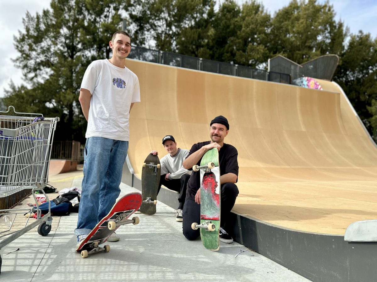 three people next to a half-pipe