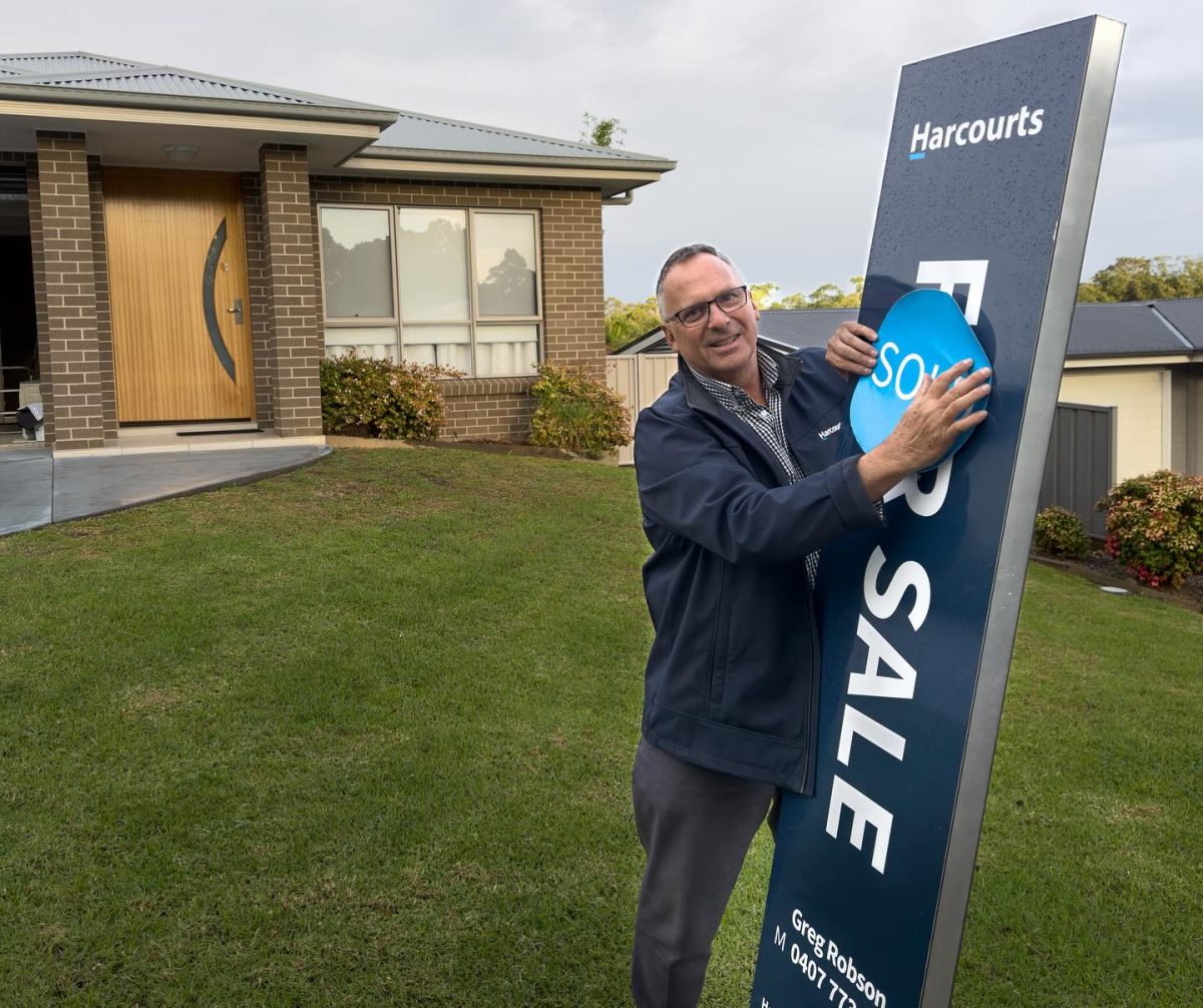 Real estate agent with sign 