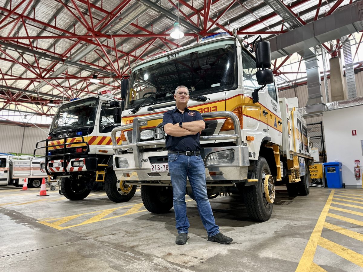 man standing near firetruck