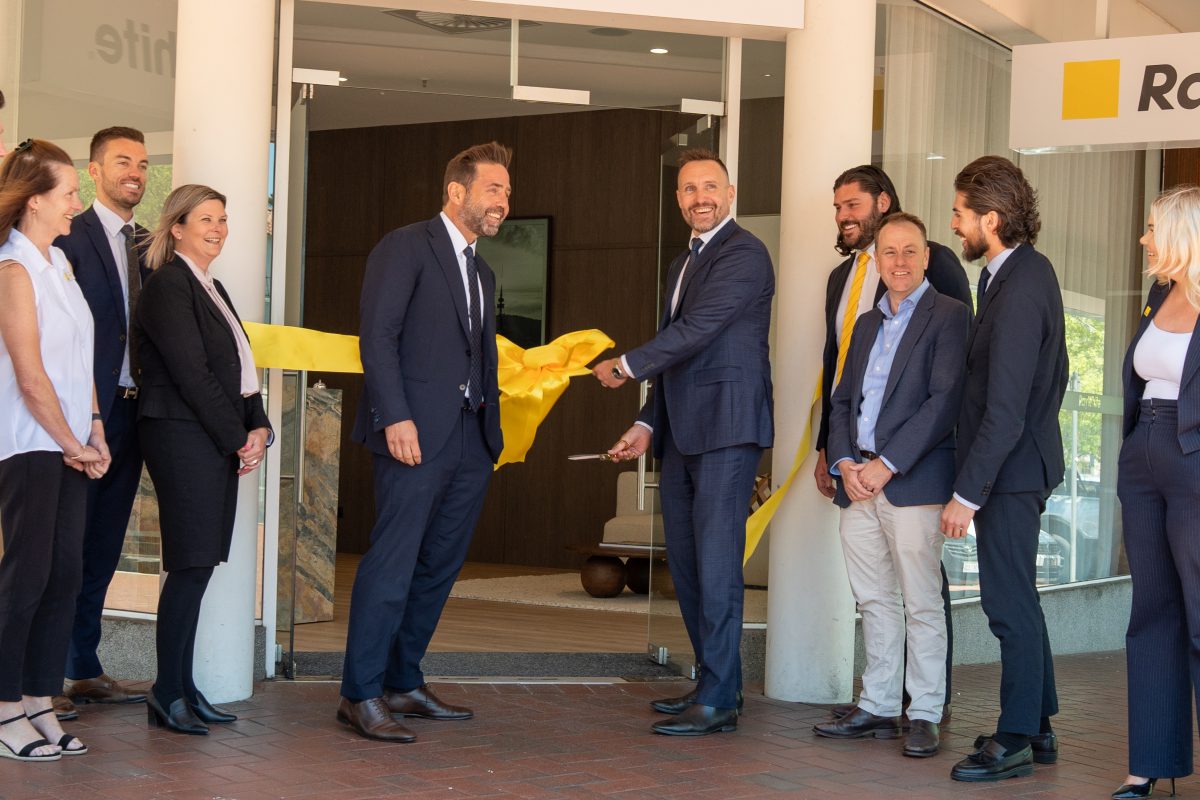 Kim Paxton, Samuel Fitzsimmons, Lisa Hyland, Dan White, Ben Faulks, Jake Battenally, Scott Jackson, Joshua Gutierrez, Zoe White cut the ribbon at the opening of the new Ray White office in Manuka