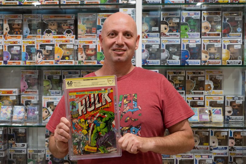 James Penney holding a signed copy of a comic book